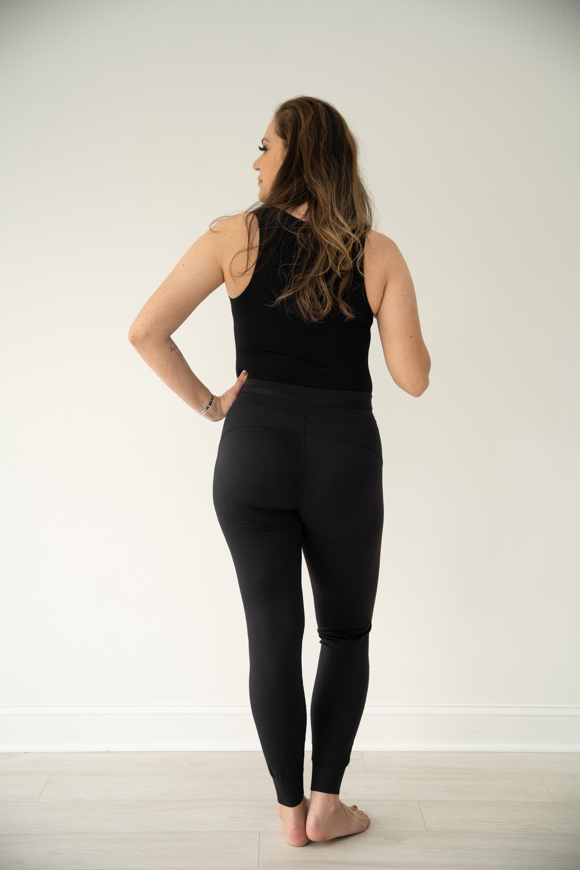 PURPOSE active joggers in Black with two front pockets, coated drawstrings at waist, and banded hems.