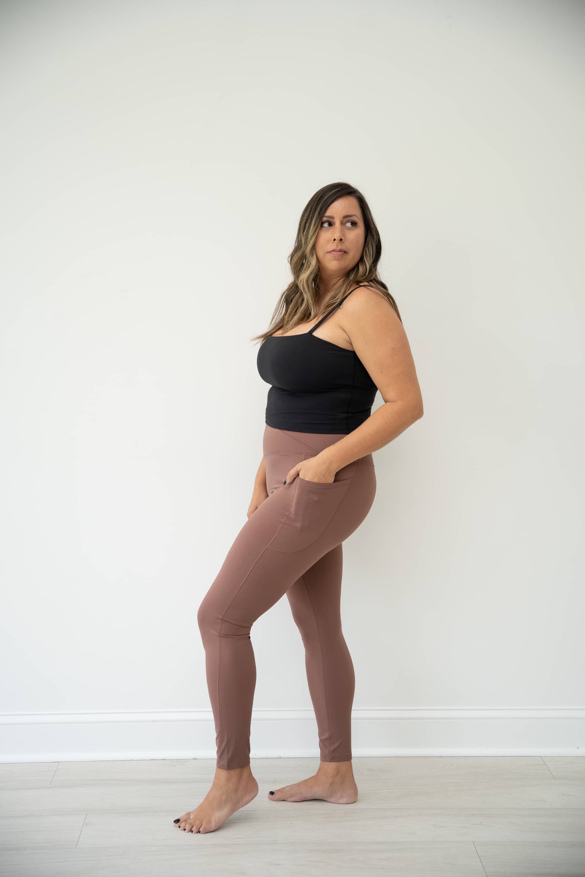Brown LUMINOUS Crossover waist leggings with two side pockets.