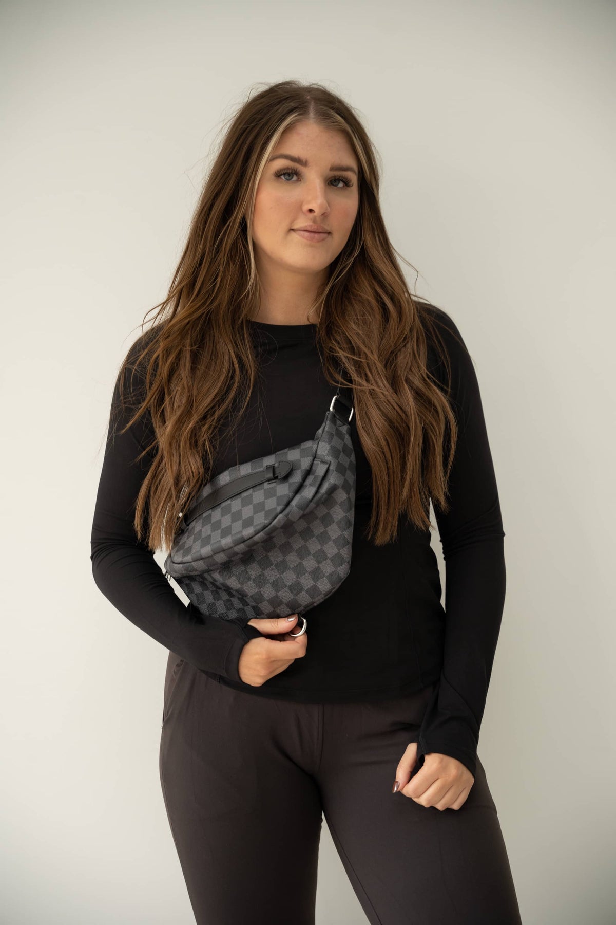 Black & Gray checkered bum bag with adjustable buckle straps and zippered closure.