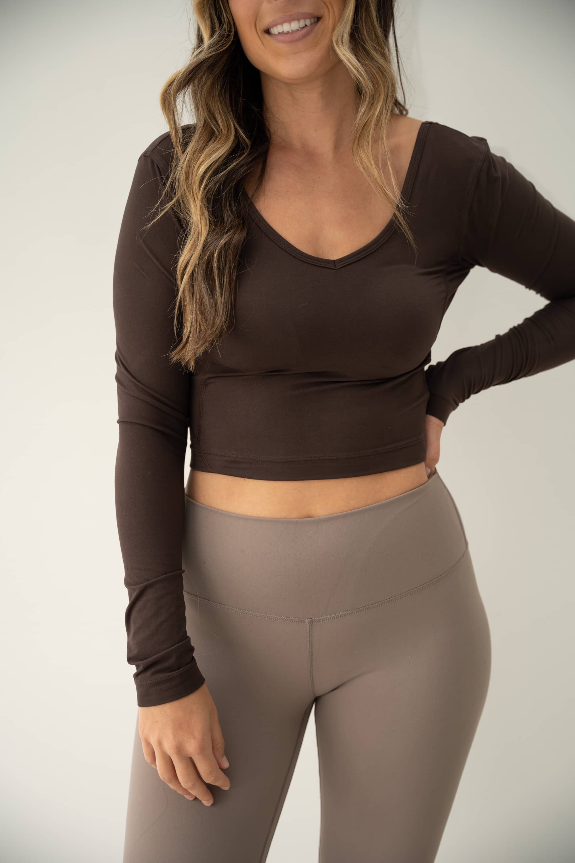 Chocolate brown long sleeved active crop top in buttery soft brushed fabric.