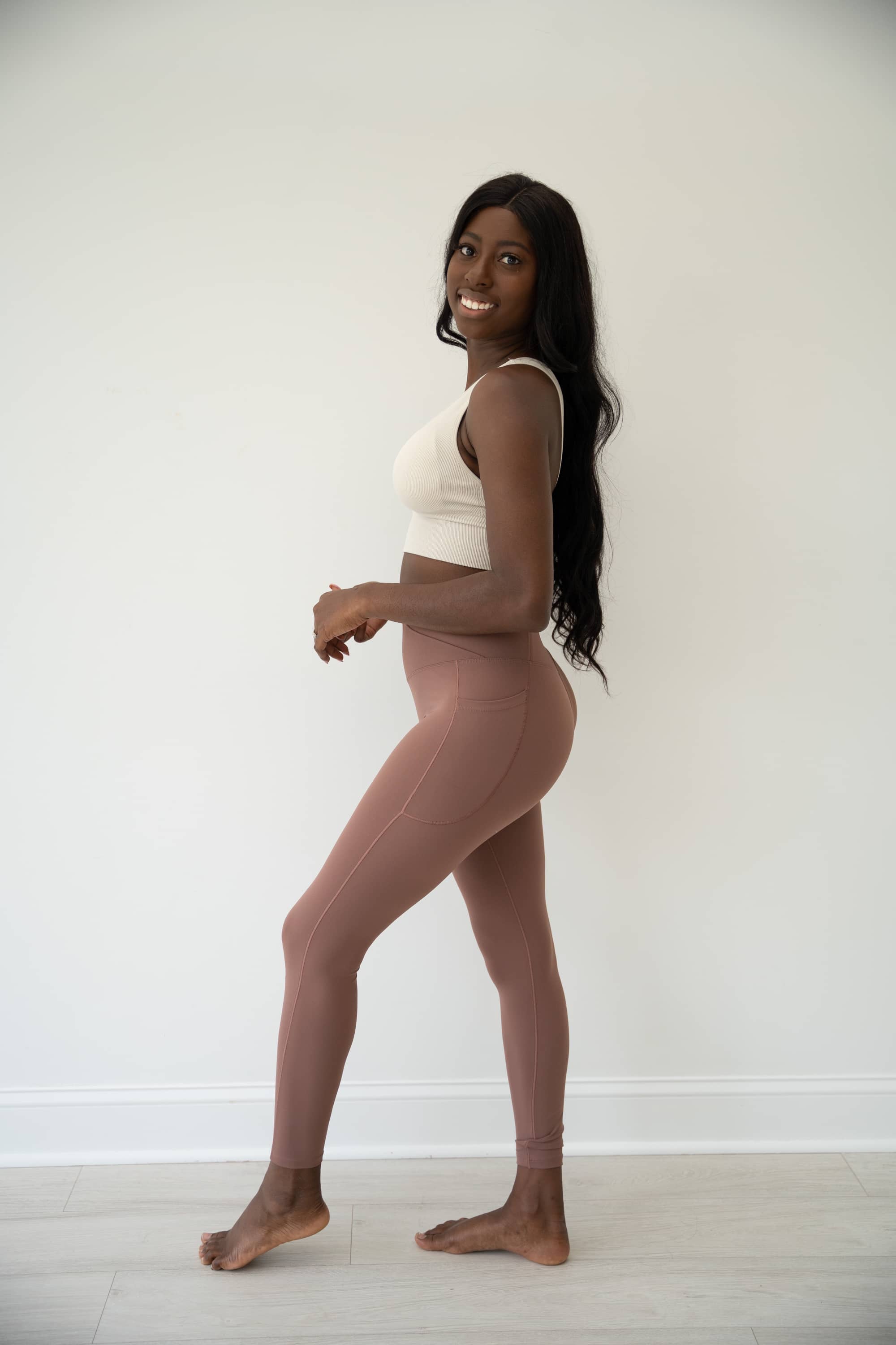 Brown LUMINOUS Crossover waist leggings with two side pockets.