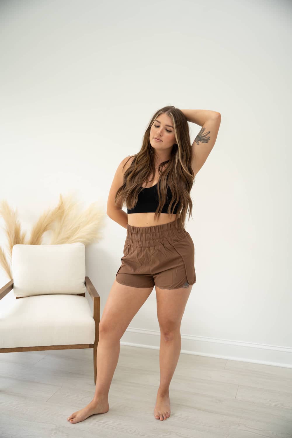 ACHIEVE Brown women's high-waisted active shorts with inner mesh lining 